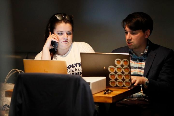  Campaign Manager  Ashley Wolsefer for Carolyn Bourdeaux and Deputy Campaign Manager Matt Yarbrough closely follow the election results during the Election Night Watch Party at KettleRock Brewing on Tuesday, May 24, 2022. Miguel Martinez / miguel.martinezjimenez@ajc.com