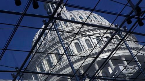 FILE - The Capitol dome on Capitol Hill is seen through a glass structure in Washington, on April 6, 2011. (AP Photo/J. Scott Applewhite, File)