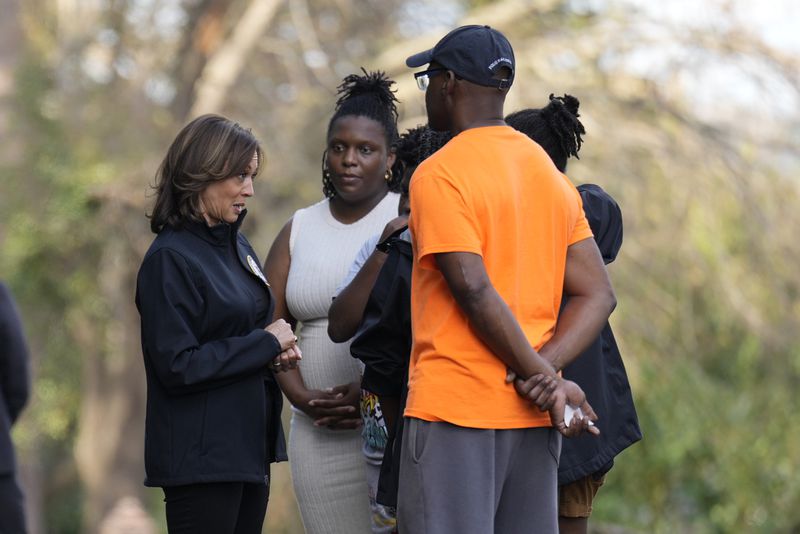 Democratic presidential nominee Vice President Kamala Harris talks with people impacted by Hurricane Helene in Augusta, Ga., Wednesday, Oct. 2, 2024. (AP Photo/Carolyn Kaster)