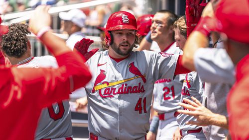 St. Louis Cardinals' Alec Burleson (41) celebrates in the dugout after hitting a home run in the third inning of a baseball game against the Atlanta Braves, Sunday, July 21, 2024, in Atlanta. (AP Photo/Jason Allen)