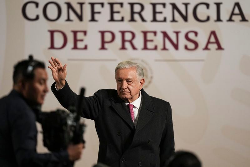 President Andres Manuel Lopez Obrador waves during his last morning press conference, or mañanera, at the National Palace in Mexico City, Monday, Sept. 30, 2024. (AP Photo/Fernando Llano)