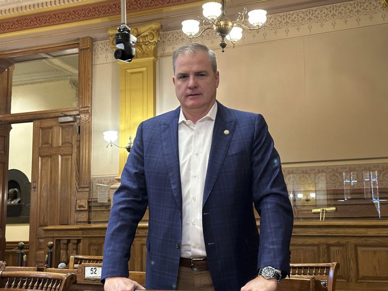 Georgia state Sen. Shawn Still, R-Johns Creek, poses for a photo on Wednesday, Aug. 21, 2024, at his desk in the state Senate chamber in the Georgia Capitol in Atlanta. (AP Photo/Jeff Amy)