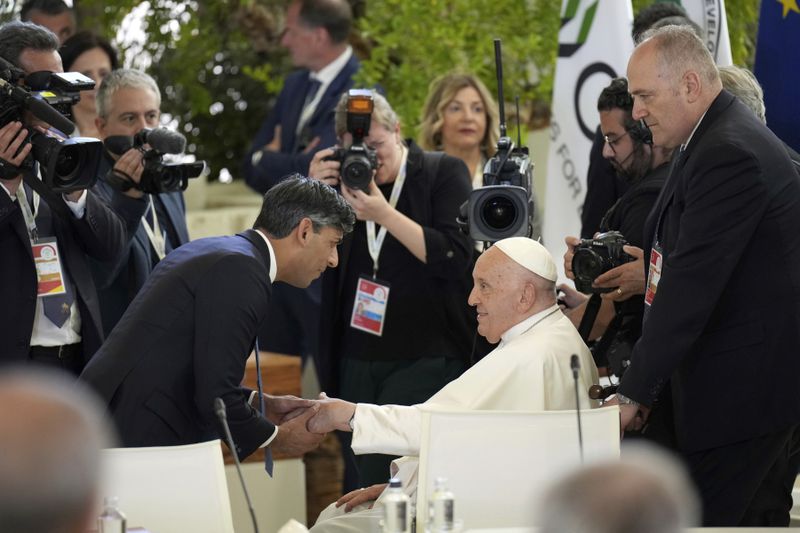 British Prime Minister Rishi Sunak welcomes Pope Francis ahead of a working session on Artificial Intelligence (AI), Energy, Africa-Mediterranean, on day two of the 50th G7 summit at Borgo Egnazia, southern Italy, on Friday, June 14, 2024. (Christopher Furlong/Pool Photo via AP)