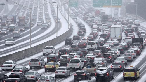 January 28, 2014 Atlanta: Traffic inches along the Connector as snow blankets the Metro on Tuesday afternoon January 28, 2014 as seen from the Pryor Street overpass. BEN GRAY / BGRAY@AJC.COM