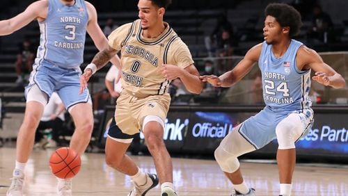 123020 ATLANTA: North Carolina guards Andrew Platek (left) and Kerwin Walton steal from Georgia Tech guard Michael Devoe in a NCAA college basketball game on Wednesday, Dec. 30, 2020, in Atlanta.   pool photo Curtis Compton / Curtis.Compton@ajc.com”