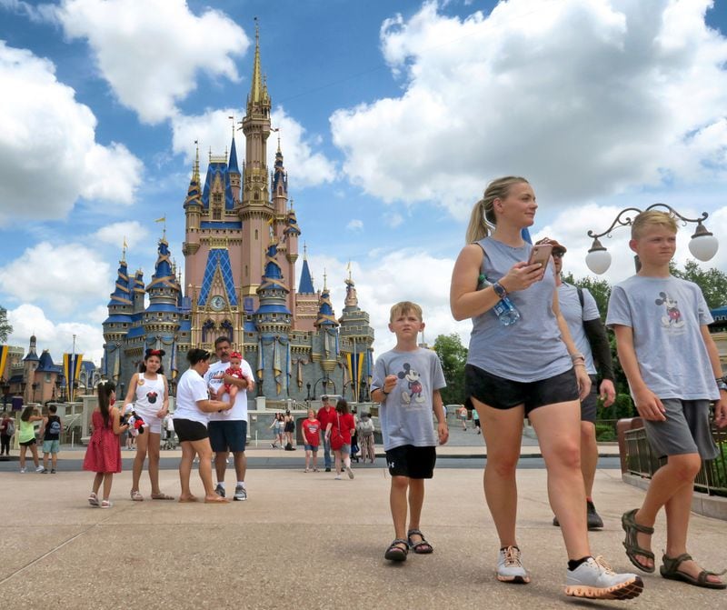 Guests walk past Cinderella Castle at the Magic Kingdom at Walt Disney World, in Lake Buena Vista, Florida. (Joe Burbank/Orlando Sentinel/TNS)