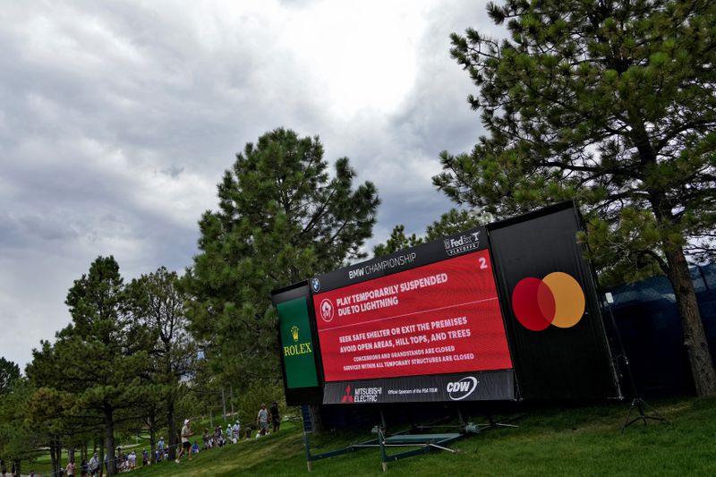 A sign stating play is suspended due to lighting is shown on the 18th fairway during the first round of the BMW Championship golf event at Castle Pines Golf Club, Thursday, Aug. 22, 2024, in Castle Rock, Colo. (AP Photo/Matt York)