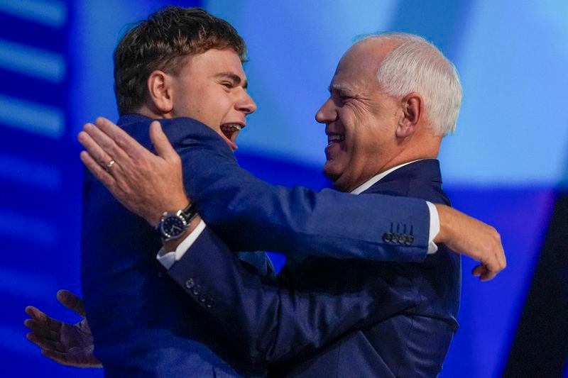 Democratic vice presidential nominee Minnesota Gov. Tim Walz hugs his son Gus during the Democratic National Convention Wednesday, Aug. 21, 2024, in Chicago. (AP Photo/Erin Hooley)