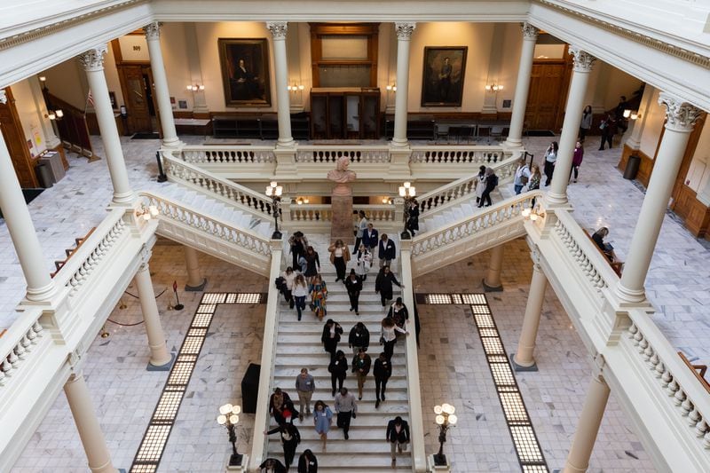 A tour group walks down the steps of the Georgia Capitol in Atlanta. Legislators returned to the Capitol earlier this month to begin crafting laws during this year's legislative session. (Arvin Temkar / arvin.temkar@ajc.com)