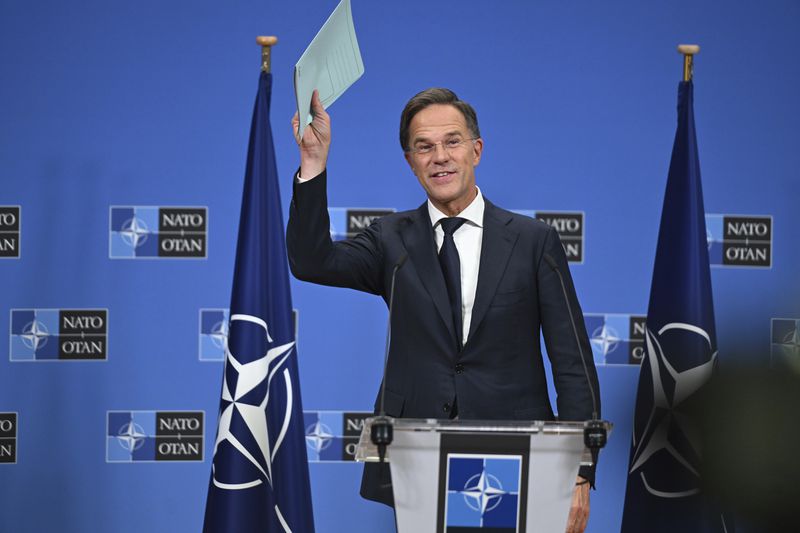 The new NATO Secretary General Mark Rutte waves to the reporters after a press conference at NATO headquarters in Brussels, Belgium, Tuesday, Oct. 1, 2024. (AP Photo/Harry Nakos)