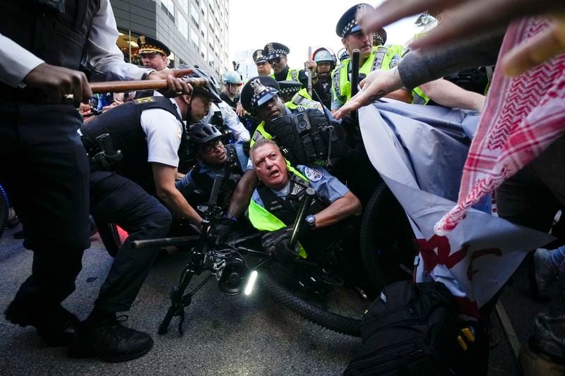 Demonstrators clash with police near the Israeli Consulate during the Democratic National Convention Tuesday, Aug. 20, 2024, in Chicago. (AP Photo/Julio Cortez)