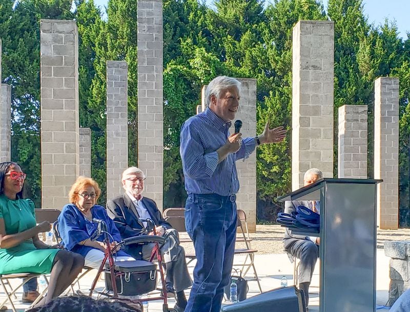 Chuck Taylor speaking at the dedication of 54 Columns Park. Pushback against the public art work, on land that Taylor's father had intended to develop, was nearly instantaneous upon its 1999 installation. Yet the next year, "54 Columns" was rated as one of the top 24 public art projects by Art in America.