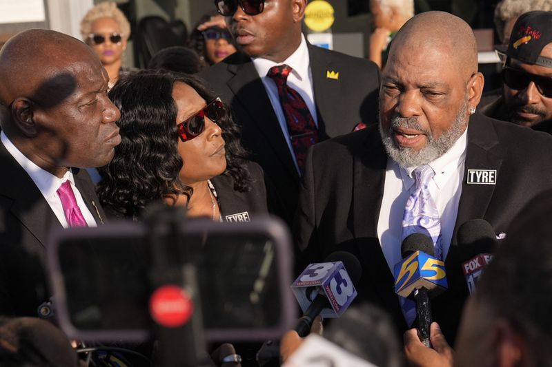 Rodney Wells, right, stepfather of Tyre Nichols, speaks during a news conference with his wife RowVaughn Wells, center, and attorney Ben Crump, left, outside the federal courthouse after three former Memphis police officers were convicted of witness tampering charges in the 2023 fatal beating of their son Nichols, Thursday, Oct. 3, 2024, in Memphis, Tenn. (AP Photo/George Walker IV)