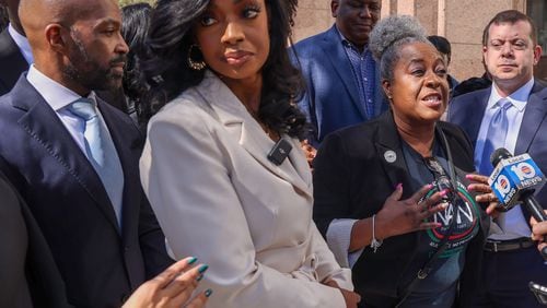 Alphonso David, left, Arian Simone, Fearless Fund co-founder/ CEO, and others listen as Serena Paramore, of the National Action Network, gives her remarks after appearing in federal court at the James Lawrence King Federal Justice Building in Miami, Florida, on Wednesday, January 31, 2024.�