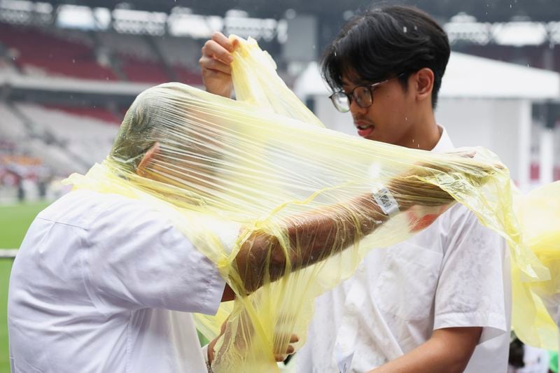 Catholic worshipers wear raincoats as they attend the holy Mass led by Pope Francis at Gelora Bung Karno Stadium in Jakarta Thursday, Sept. 5, 2024. (Ajeng Dinar Ulfiana/Pool Photo via AP)