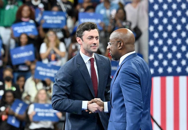 U.S. Sen. Jon Ossoff (left) and U.S. Sen. Raphael Warnock shake hands at a rally for Vice President Kamala Harris at the Georgia State University’s convocation center in Atlanta on Tuesday, July 30, 2024. It is her first campaign event in Georgia since she became the presumptive Democratic nominee. (Hyosub Shin/AJC)