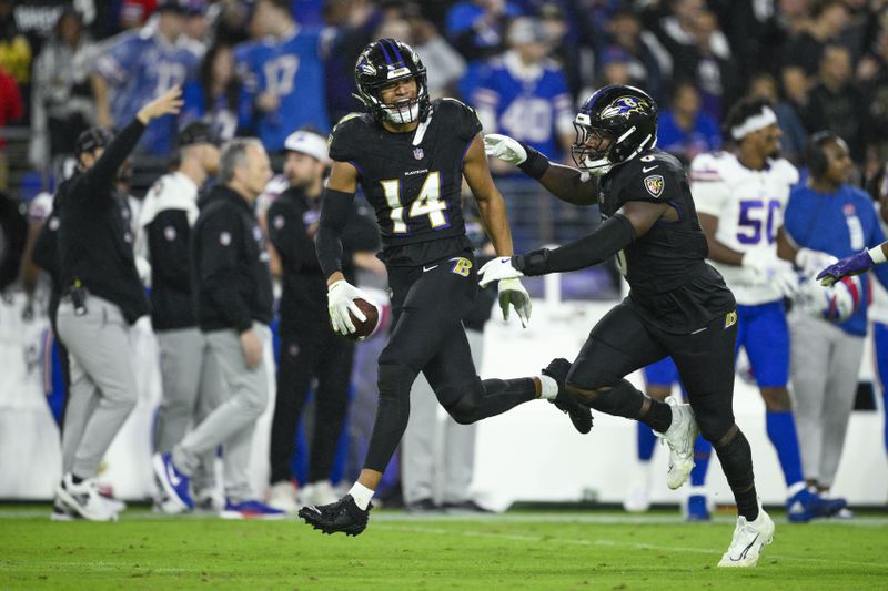 Baltimore Ravens safety Kyle Hamilton (14) reacts with teammate linebacker Roquan Smith after recovering a fumble by Buffalo Bills quarterback Josh Allen during the second half of an NFL football game, Sunday, Sept. 29, 2024, in Baltimore. (AP Photo/Nick Wass)