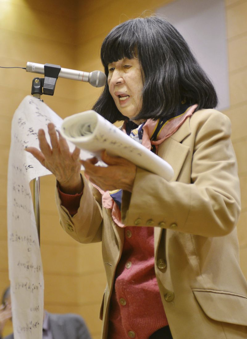 Kazuko Shiraishi reads a poetry in Tokyo on March 11, 2016. Shiraishi, a leading name in modern Japanese “beat” poetry, known for her dramatic readings, at times with jazz music, died of heart failure on June 14, according to a Tokyo publisher of her works on Wednesday, June 19, 2024. She was 93. (Kyodo News via AP)
