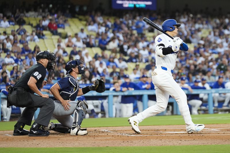 Los Angeles Dodgers designated hitter Shohei Ohtani (17) lines out during the first inning of a baseball game against the Tampa Bay Rays in Los Angeles, Friday, Aug. 23, 2024. (AP Photo/Ashley Landis)