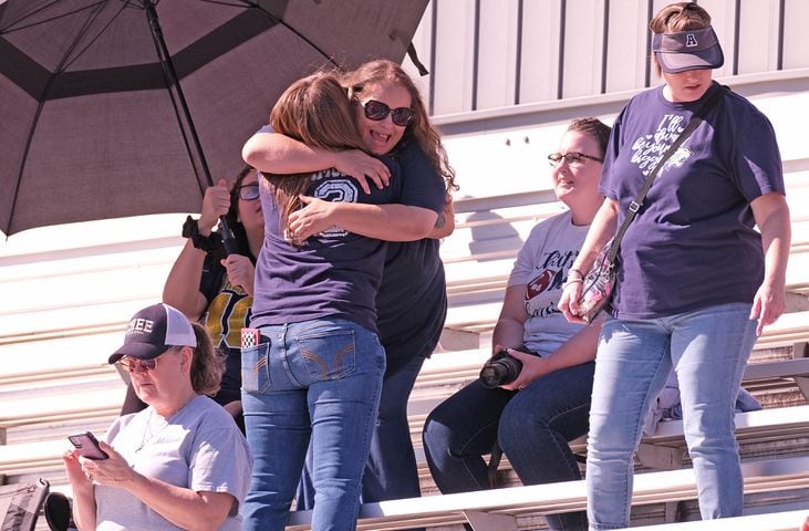 Fans hug in the stands before the game. 
Apalachee High School returned to the field against Athens Clarke Central Saturday September 28, 2024 in their first game since the school schooting earlier in the month.

 Nell Carroll for the Journal Constitution