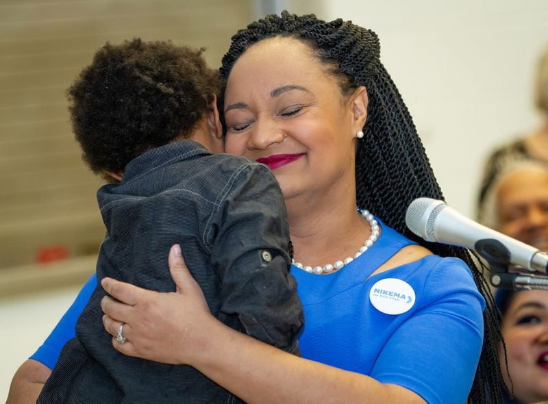 Georgia state Sen. Nikema Williams holds her son, Carter Small, after she gave her speech in January 2019 seeking to become chairwoman of the Democratic Party of Georgia. Williams won the position with a promise to expand the strategy Stacey Abrams embraced during the 2018 governor's race: an intense focus on voters who feel neglected by politicians, muscular opposition to Republican policies and an embrace of a liberal agenda. STEVE SCHAEFER / SPECIAL TO THE AJC