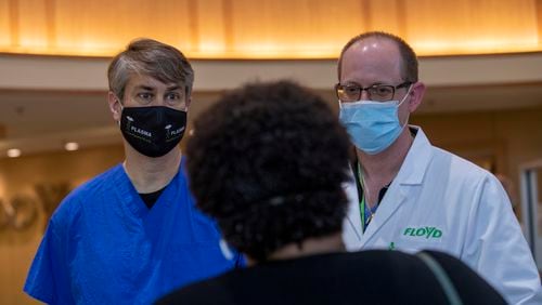 Medical Director Hospitalist at Floyd Medical Center, Dr. Daniel Valancius, right, and Radiologist Matthew McClain, MD, left, speak with Josetta Cooke at Floyd Medical Center in Rome earlier this week. In March 2020, Cooke became one of the first diagnosed COVID-19 patients at Floyd Medical Center. (Alyssa Pointer / Alyssa.Pointer@ajc.com)