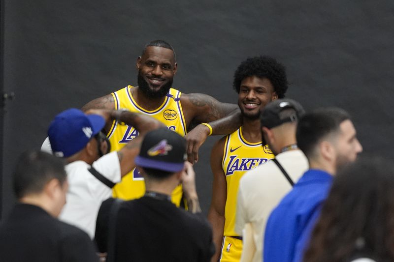 Los Angeles Lakers' LeBron James, left, and his son, Bronny James, pose for photos during the NBA basketball team's media day in El Segundo, Calif., Monday, Sept. 30, 2024. (AP Photo/Jae C. Hong)