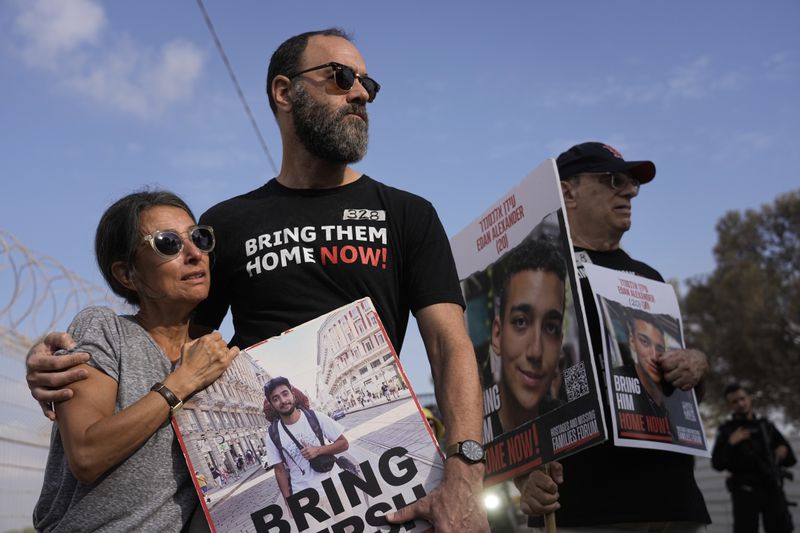 Relatives and friends of hostages held in the Gaza Strip by the Hamas militant group take part in a protest calling for their release in the kibbutz Nirim, southern Israel, Thursday, Aug. 29, 2024. (AP Photo/Tsafrir Abayov)