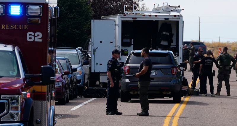 Law enforcement officers gather outside a building following a shooting at an apartment complex Thursday morning, Sept. 12, 2024, in Broomfield, Colo., a suburb of Denver. (AP Photo/David Zalubowski)