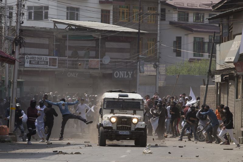 Kashmiri protesters throw bricks and rocks at an armored vehicle of Indian police during a protest in Srinagar, Indian controlled Kashmir, Friday, May 31, 2019. (AP Photo/Dar Yasin, File)