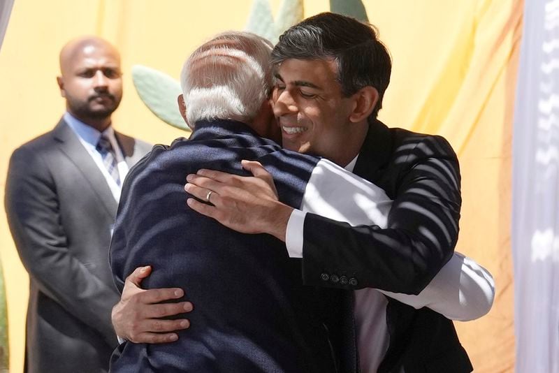 British Prime Minister Rishi Sunak, right, hugs Prime Minister of India Narendra Modi on the sidelines of day two of the 50th G7 summit, in Borgo Egnazia, southern Italy, Friday, June 14, 2024. (Christopher Furlong/Pool Photo via AP)