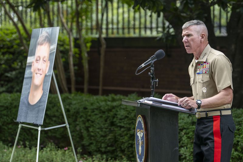 Commandant of the Marine Corps Gen. Eric Smith, speaks during a ceremony posthumously awarding Cpl. Spencer Collart, photo at left, with the Navy and Marine Corps medal on Monday, Sept. 16, 2024 in Washington. (AP Photo/Kevin Wolf)