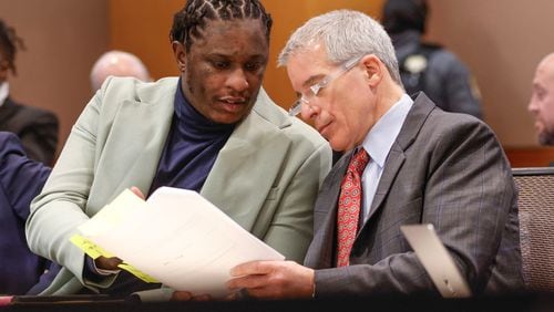 Atlanta rapper Young Thug speaks with defense attorney Brian Steel during his ongoing gang and racketeering trial at Fulton County Courthouse on Tuesday, Jan. 2, 2024. (Natrice Miller/The Atlanta Journal-Constitution/TNS)