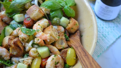 Panzanella, a traditional Italian bread salad, is transformed into a filling salad supper with the addition of garlicky shrimp. (Virginia Willis for The Atlanta Journal-Constitution)