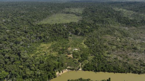 FILE - A river borders an area that has been illegally deforested by land-grabbers and cattle farmers in an extractive reserve in Jaci-Parana, Rondonia state, Brazil, July 11, 2023. (AP Photo/Andre Penner, File)