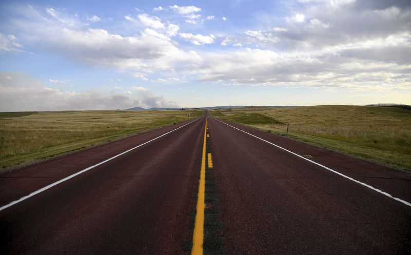 A road divides the plains outside of Lusk, Wyo., on July 30, 2024. (AP Photo/Thomas Peipert)