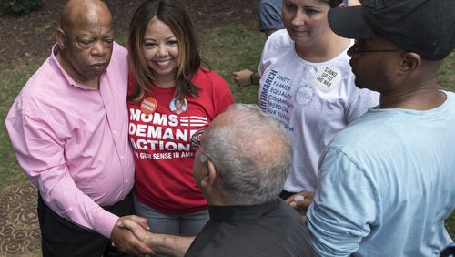 In this file photo, U.S. Rep. John Lewis stands with Lucy McBath at a rally to protest gun violence. McBath was one of two women added to the November general election, winning the Democratic nomination to face U.S. Rep. Karen Handel, R-Roswell, in a Sixth District congressional contest. Carolyn Bourdeaux won the Democratic nomination in the Seventh District. She’ll face U.S. Rep. Rob Woodall, R-Lawrenceville. DAVID BARNES / DAVID.BARNES@AJC.COM