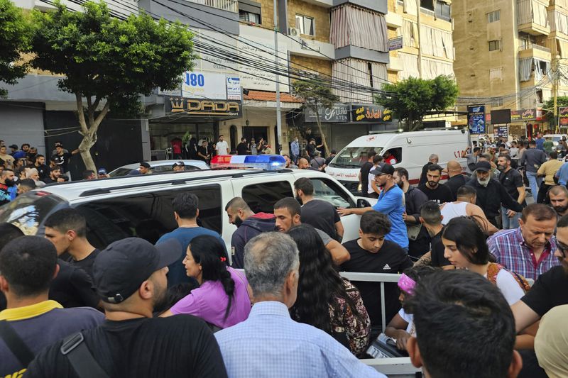 Ambulances arrive at the scene of an Israeli missile strike in the southern suburbs of Beirut, Friday, Sept. 20, 2024. (AP Photo/Hassan Ammar)