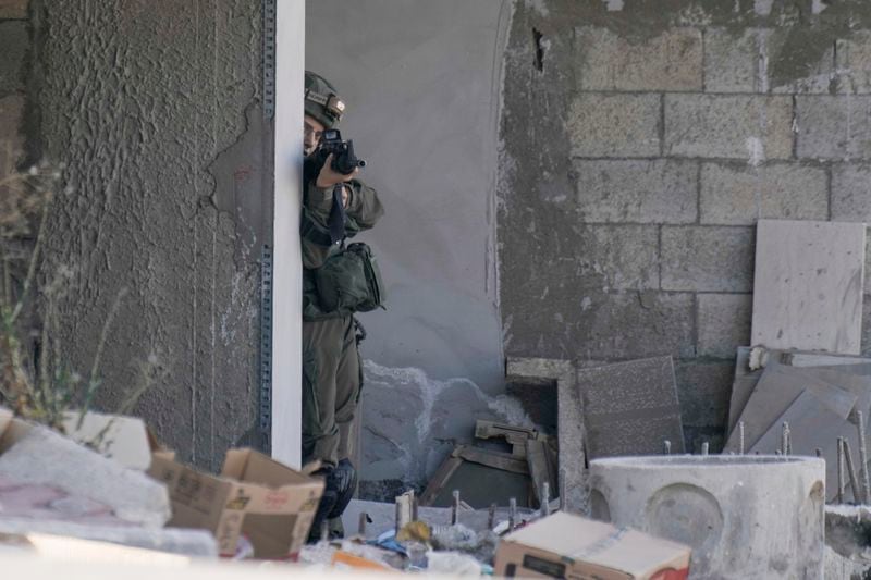 An Israeli soldier aims her rifle during an army raid in Tubas, West Bank, on Wednesday, Sept. 11, 2024. (AP Photo/Majdi Mohammed)