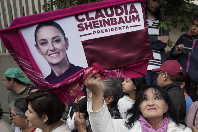 Supporters gather outside the house of Claudia Sheinbaum on her inauguration day as president in Mexico City, Tuesday, Oct. 1, 2024. (AP Photo/Aurea Del Rosario)