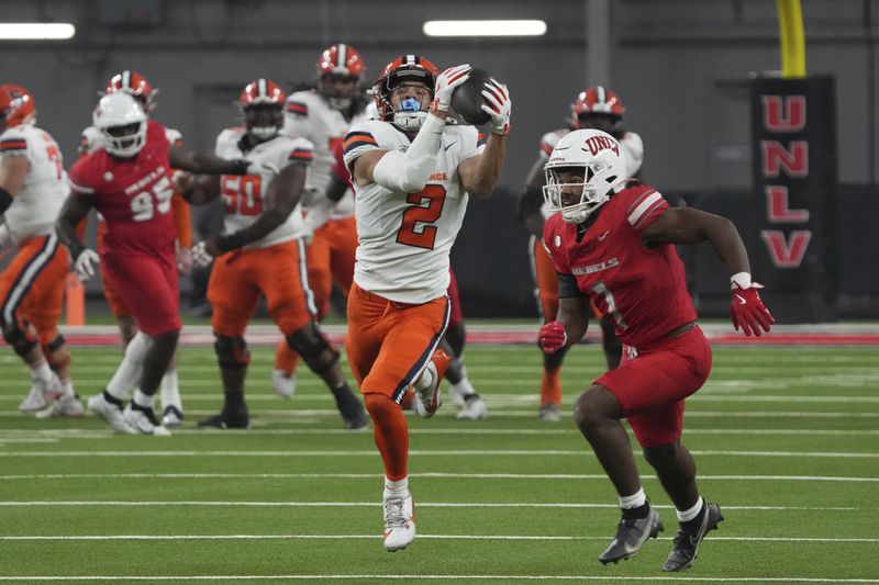 Syracuse wide receiver Trebor Pena (2) makes the catch over UNLV defensive back Jalen Catalon (1) in the first half during an NCAA college football game, Friday, Oct. 4, 2024, in Las Vegas. (AP Photo/Rick Scuteri)