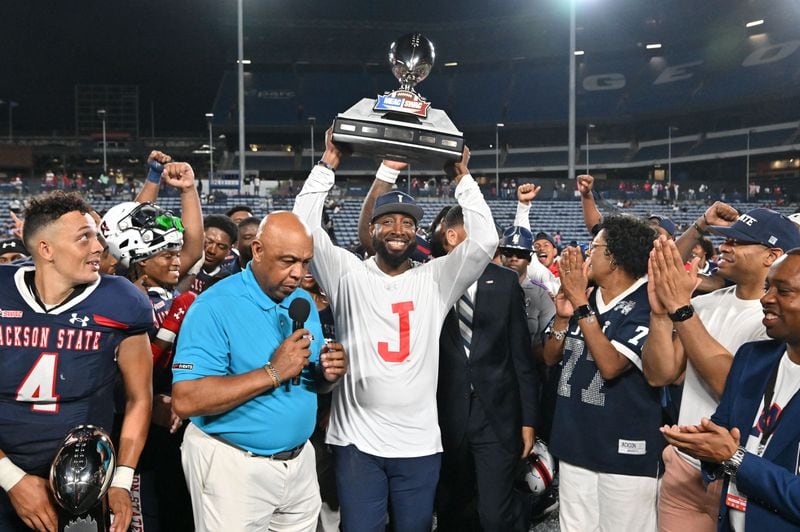 Jackson State's head coach T.C. Taylor holds up the trophy to celebrate  the victory during the 2023 MEAC/SWAC Challenge at Center Parc Stadium, Saturday, August 26, 2023, in Atlanta.  (Hyosub Shin / Hyosub.Shin@ajc.com)