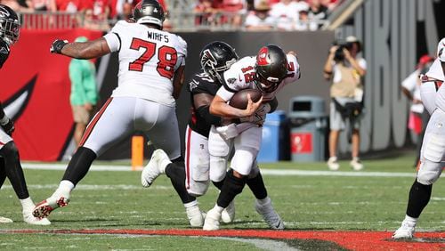 Falcons defensive end Grady Jarrett brings down Buccaneers quarterback Tom Brady, resulting in a controversial roughing-the-passer penalty earlier this season. (Luis Santana/Tampa Bay Times/TNS)
