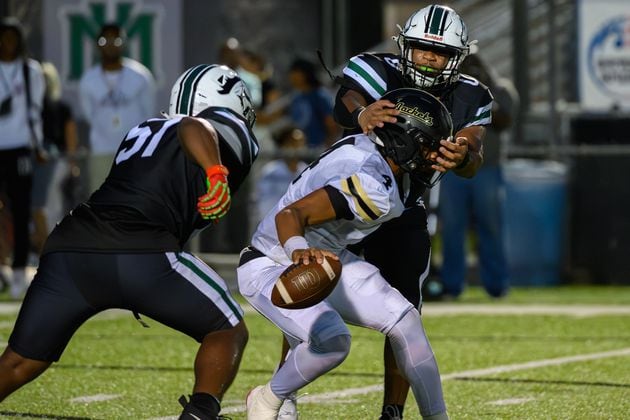 Jaden Duckett, quarterback for Sprayberry High School, escapes a sack during the Sprayberry at Kennesaw Mountain high school football game in Kennesaw, GA on Aug. 30, 2024. (Jamie Spaar for the Atlanta Journal Constitution)