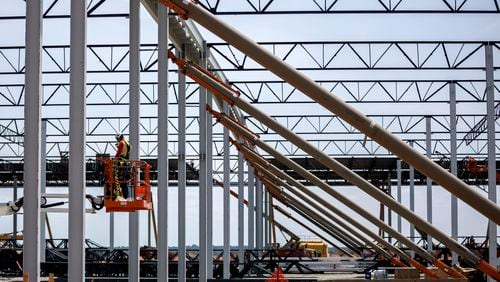 Workers erect a large steel frame building on July 5, 2023, at the Hyundai Metaplant site in Ellabell, Ga. (Stephen B. Morton/AJC)