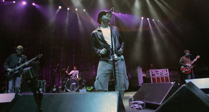 FILE - The British rock band Oasis performs at the Tweeter Center in Mansfield, Mass., Friday, June 24, 2005. (AP Photo/Robert E. Klein, File)