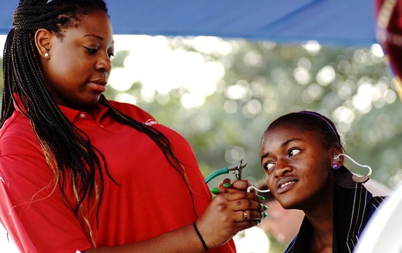 Daughter, Carrie Mutombo helping with hearing aids at the Biamba Marie Mutombo hospital. CONTRIBUTED