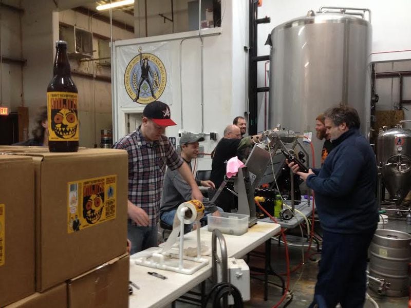 Burnt Hickory Brewery crew bottling The Didjits Blood Orange IPA, with owner/brewmaster Scott Hedeen (right).