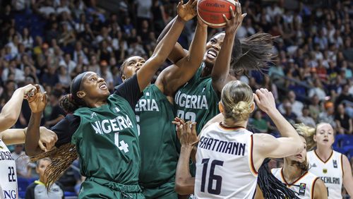 Germany's Alina Hartmann, right, tries to get the ball against, from right, Blessing Ejiofor, Lauren Ebo and Elizabeth Balogun from Nigeria during the Women International Basketball match between Germany and Nigeria at the Uber Arena in Berlin, Friday July 19, 2024. (Andreas Gora/dpa via AP)