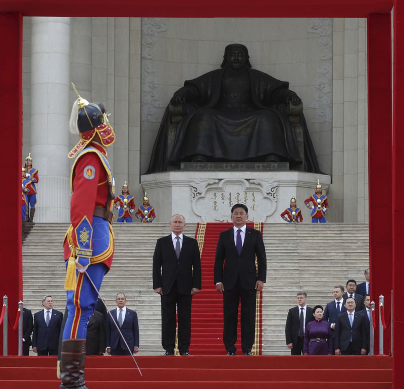 Russian President Vladimir Putin, center left, and Mongolian President Ukhnaagiin Khurelsukh, center right, attend a welcome ceremony in Sukhbaatar Square in Ulaanbaatar, Mongolia, Tuesday, Sept. 3, 2024. (Vyacheslav Prokofyev, Sputnik, Kremlin Pool Photo via AP)